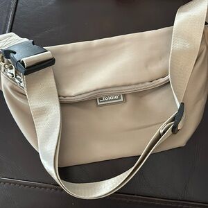 Foldie beige travel crossbody.